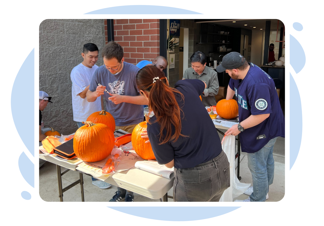 FuelCloud's team carving pumpkins outside